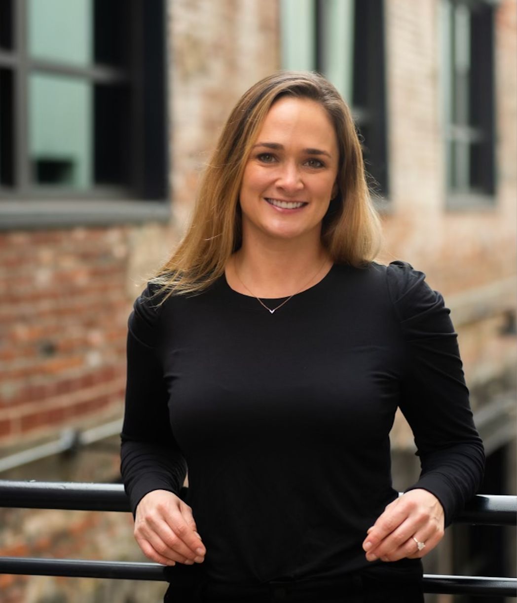Press Hook founder Michelle Songy standing by a brick building