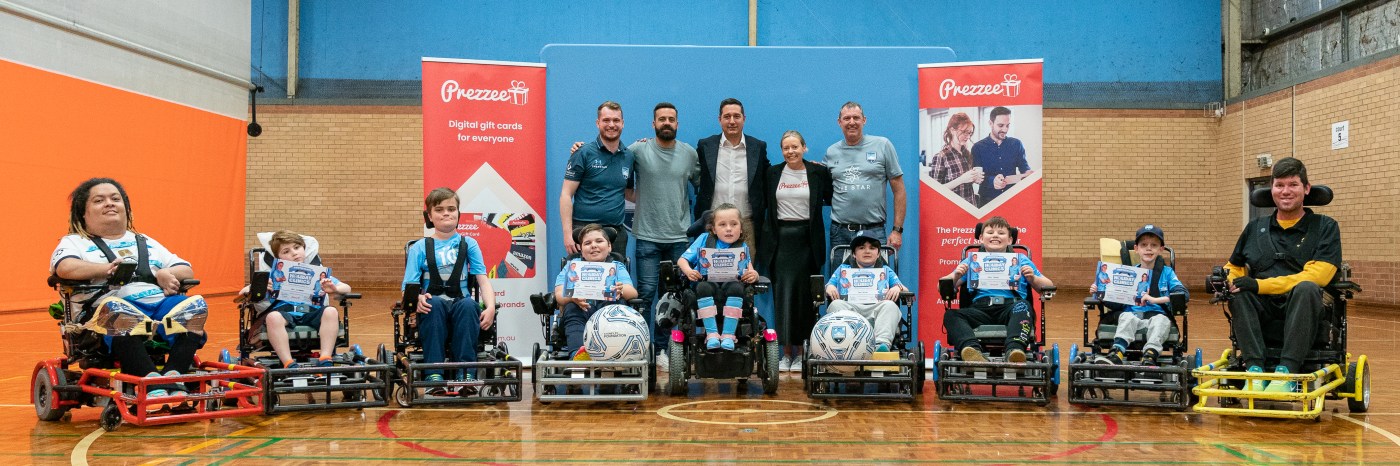 Participants and supporters gathered at a Sydney FC Foundation powerchair football clinic