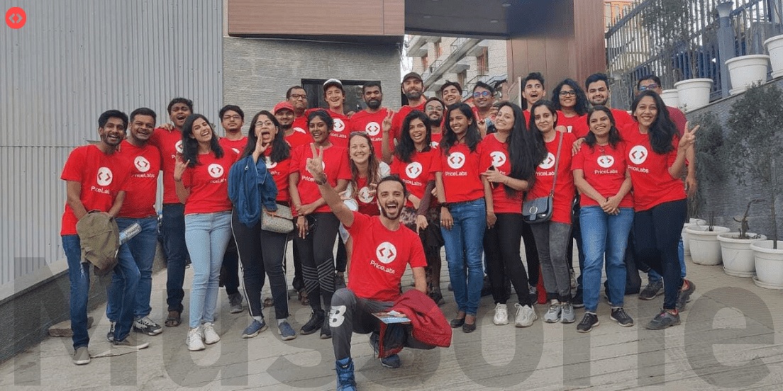 PriceLabs team members gathered outdoors wearing red company shirts