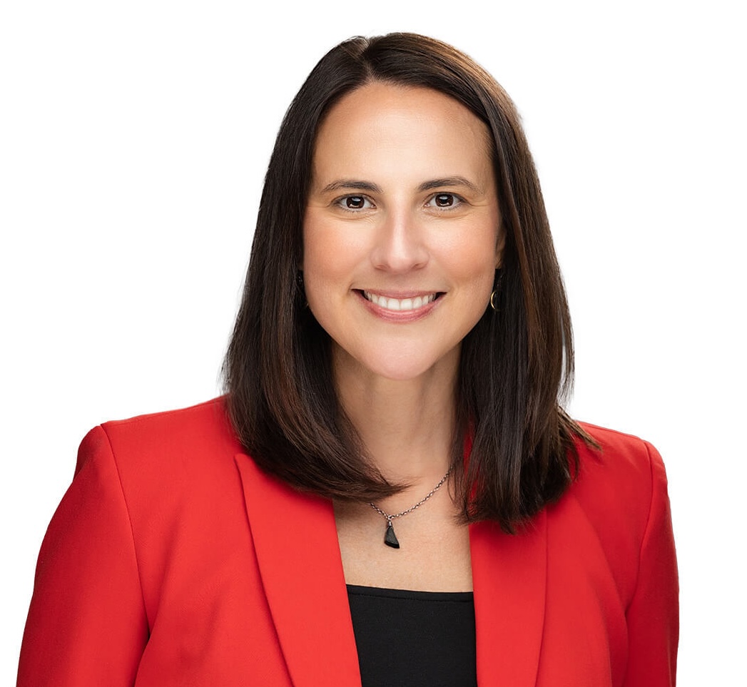 Priceline CEO Brigit Zimmerman wearing a red jacket
