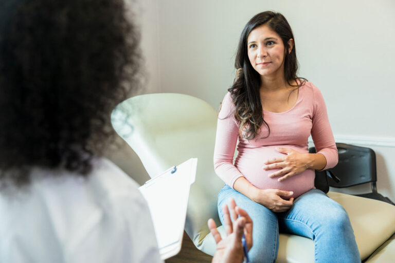 A pregnant patient speaking with a healthcare professional
