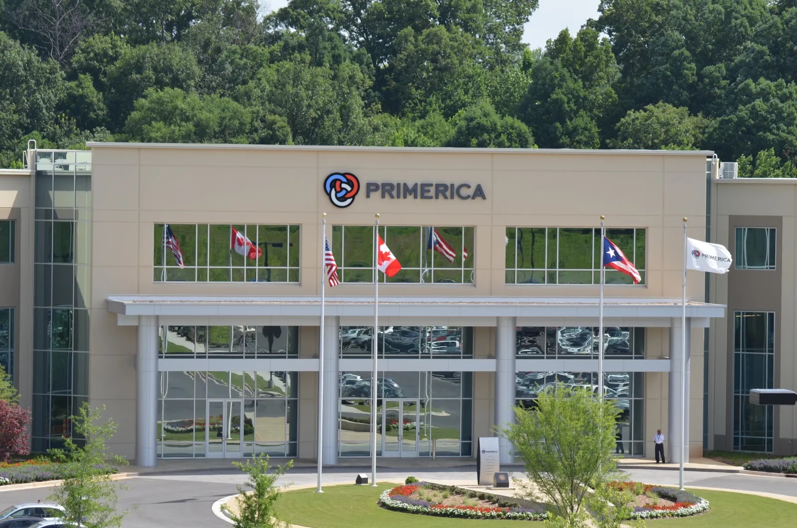 Primerica’s three-story headquarters in Duluth, Georgia, with flags outside the entrance