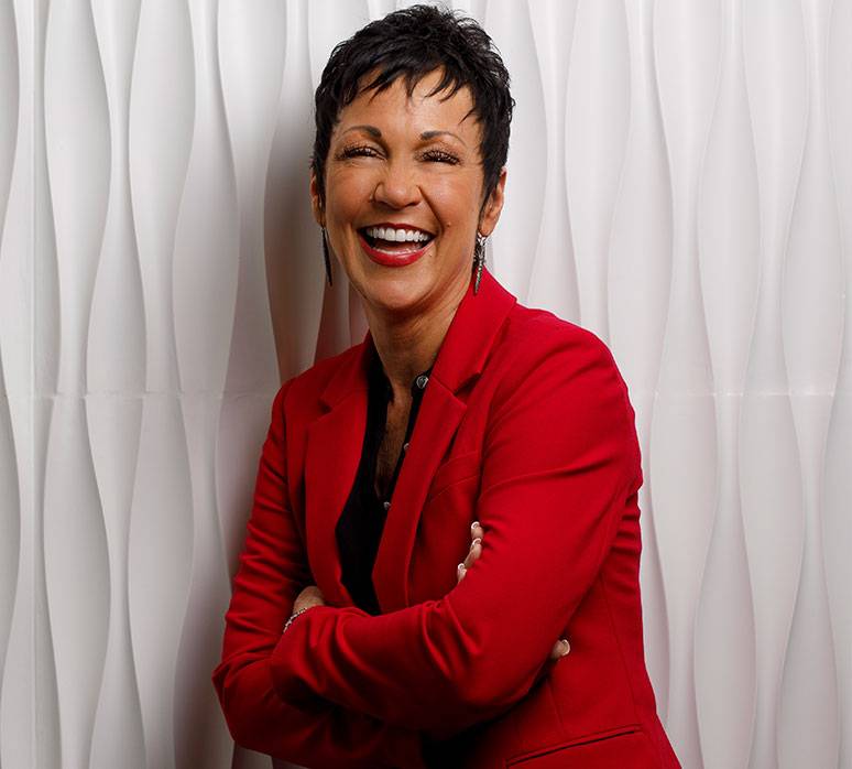 Priority Marketing founder Teri Hansen in a red suit
