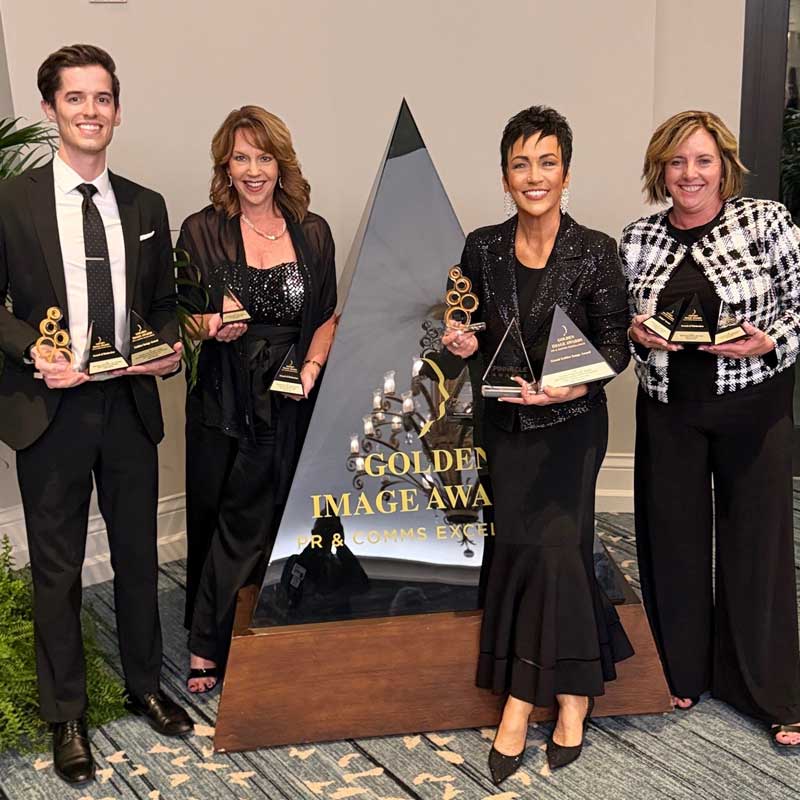 Priority Marketing team members holding Golden Image Awards