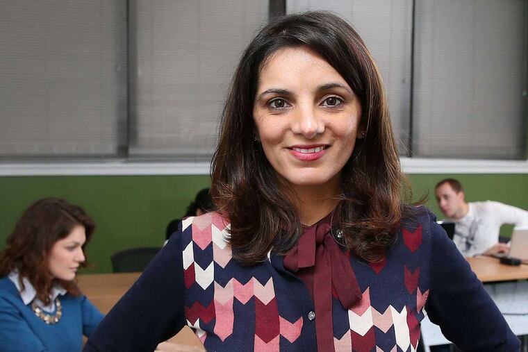 Priya Bhutani in a shared workspace, with colleagues working behind her