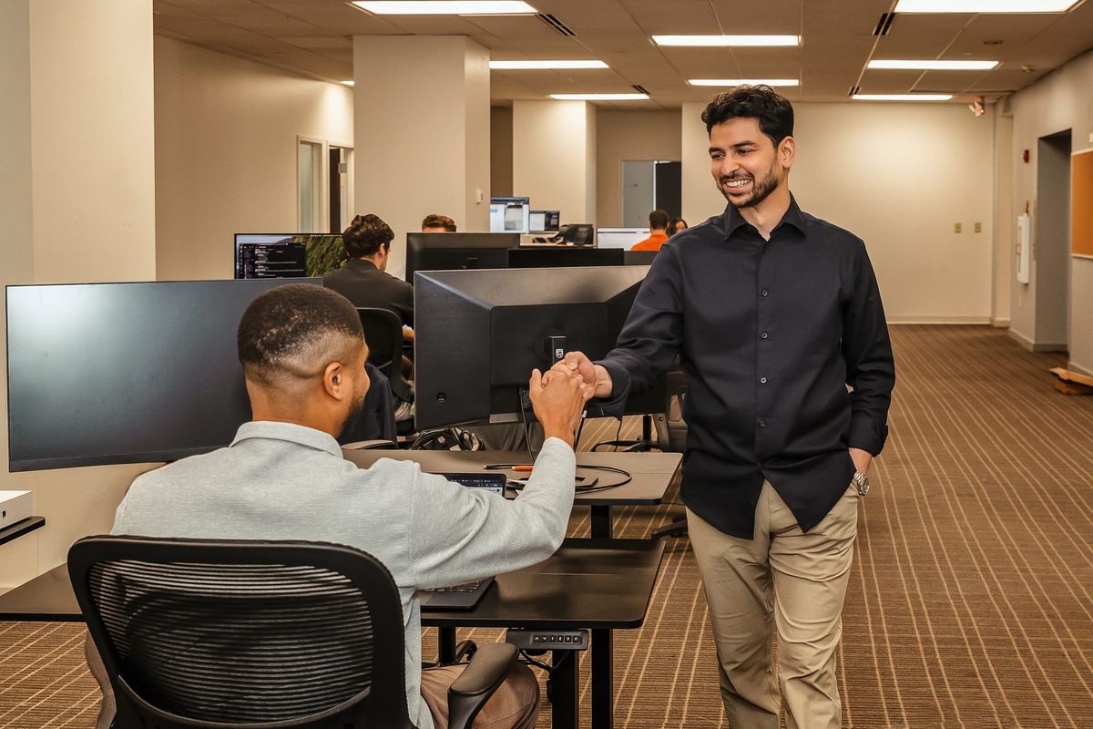 Priyang Shah greeting a colleague in Healia's Columbus office