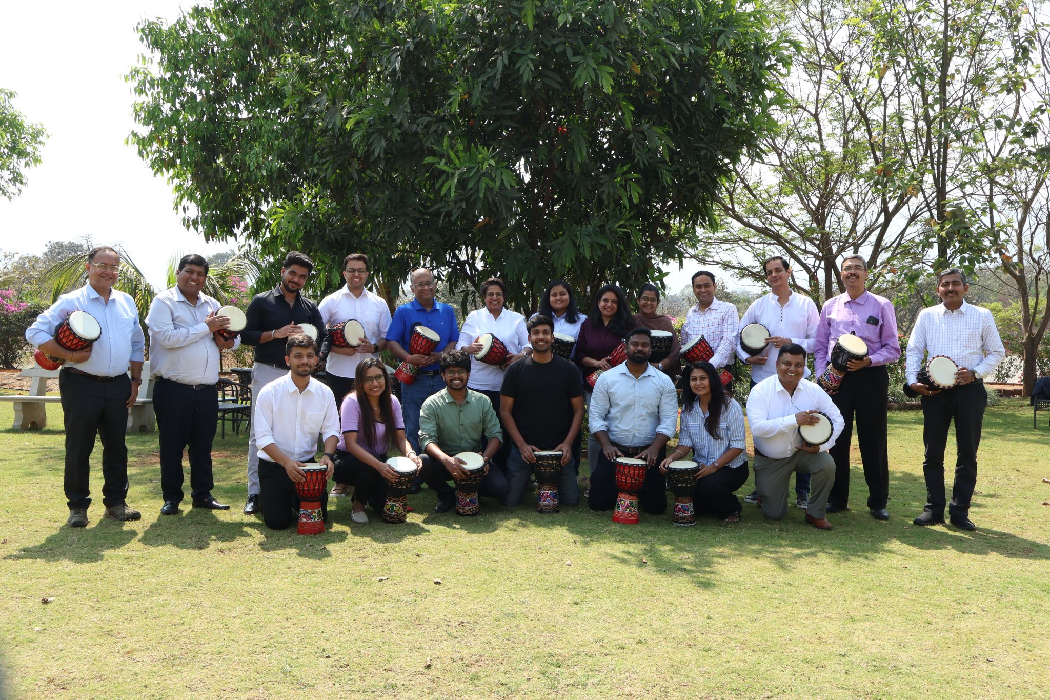 The NavAI team outdoors, posing together with hand drums
