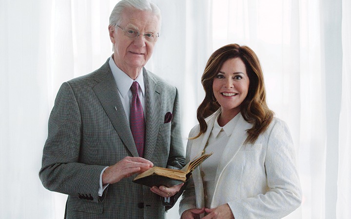 Bob Proctor and Sandy Gallagher standing together with an open book