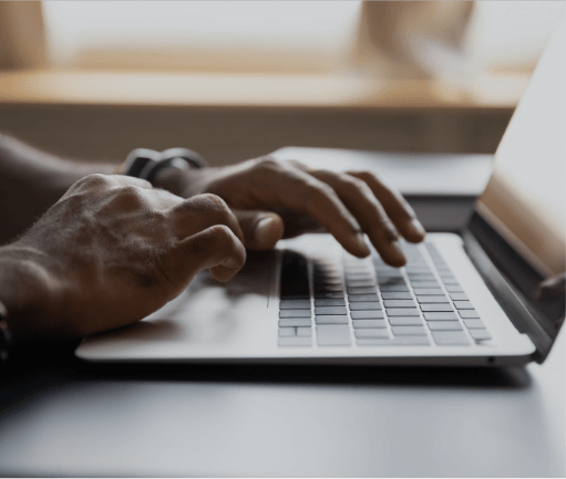 Illustration of hands typing on a keyboard with automated proctoring running