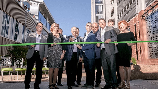 An archival group photograph of the Raleigh office ribbon-cutting ceremony