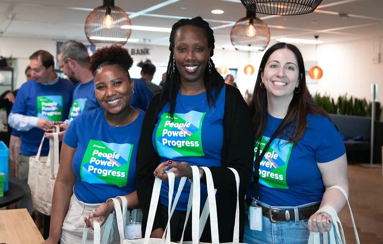 Progress employees wearing People Power Progress shirts in an office