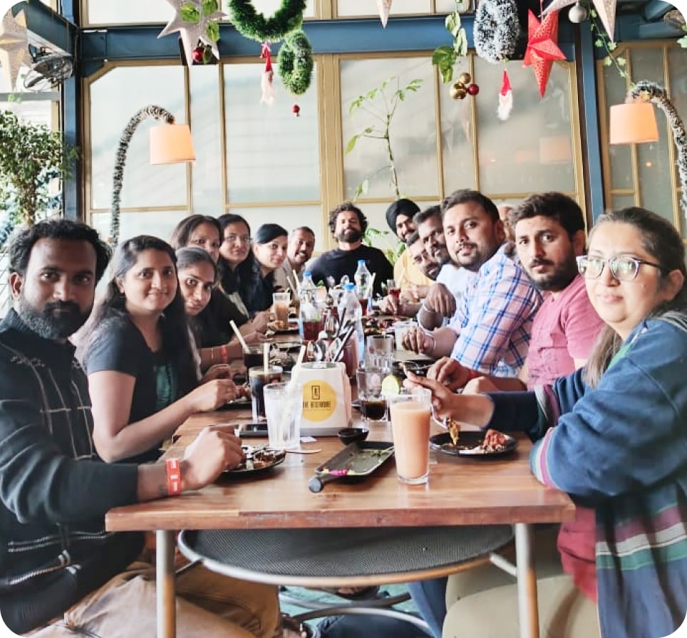ProHance colleagues gathered around a restaurant table in a photo from the company careers page