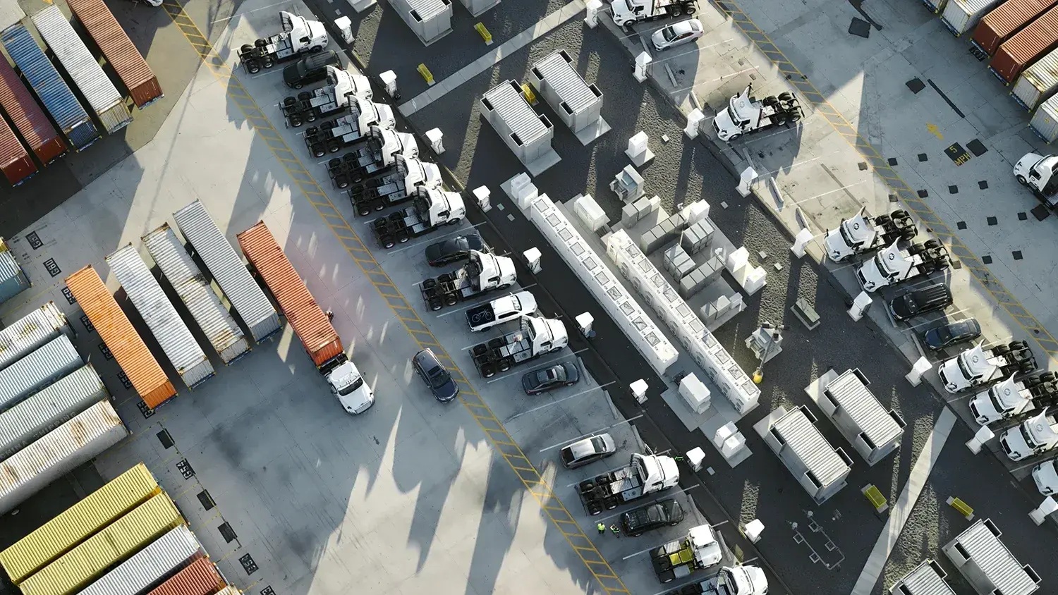 Aerial view of electric truck charging bays and rows of generator equipment at Prologis’s Torrance depot