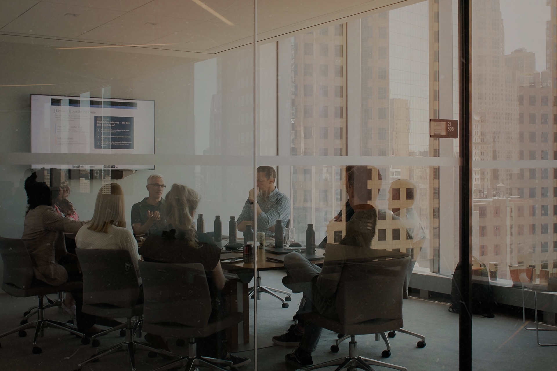Propeller colleagues meeting around a conference table behind glass walls
