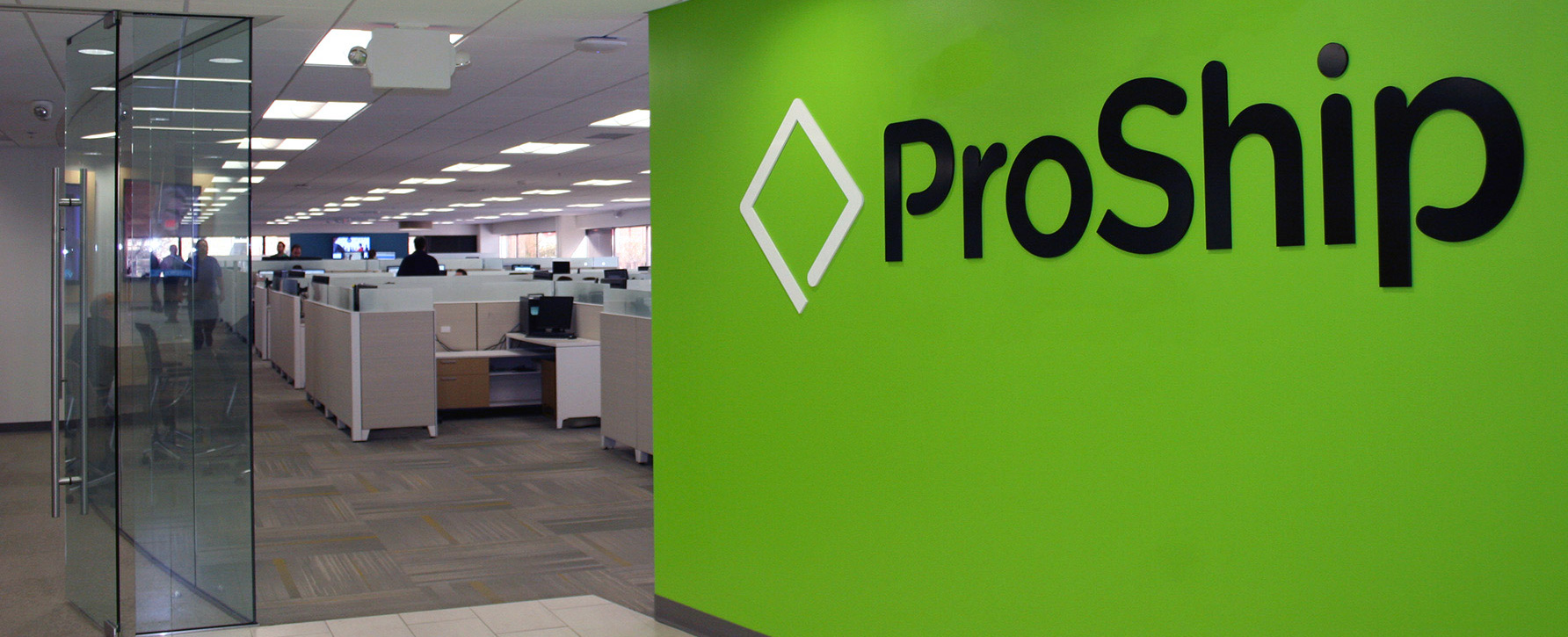 ProShip's Brookfield office with a green logo wall and open workspace