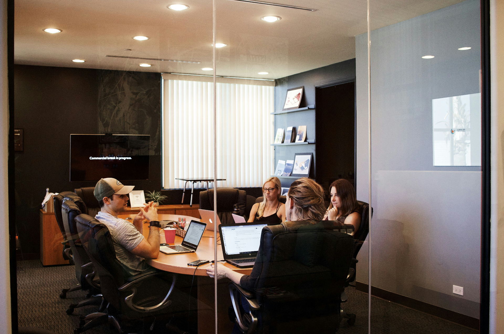 A Proterra team meeting around a conference table in the agency's office