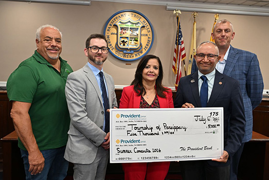 Provident Bank representatives and community partners holding a check for the Parsippany-Troy Hills summer concert series