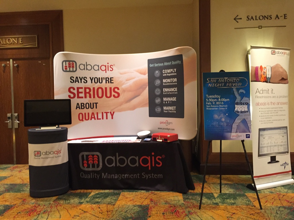 Historical abaqis conference display with quality messaging and a disco-themed San Antonio event poster