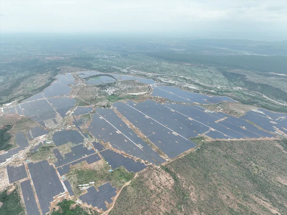 Aerial photograph of extensive solar arrays across the ArcelorMittal project site in Kurnool