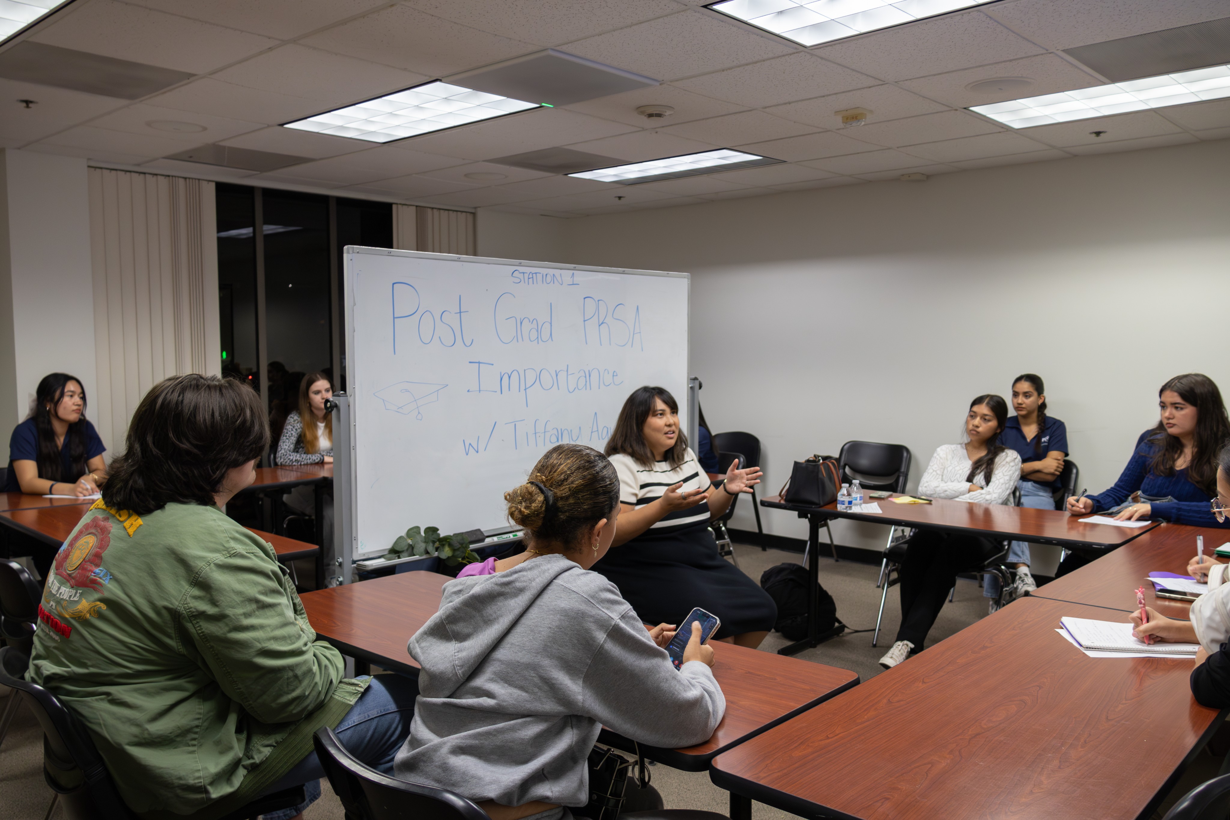 CSUF PRSSA members gathered around a whiteboard during a networking workshop