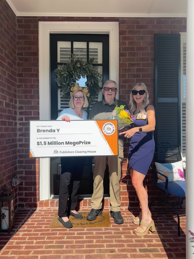 Brenda Y. and companions on a porch holding a PCH $1.5 million MegaPrize check