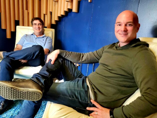 Pulumi co-founders Eric Rudder and Joe Duffy seated in the company's Seattle office