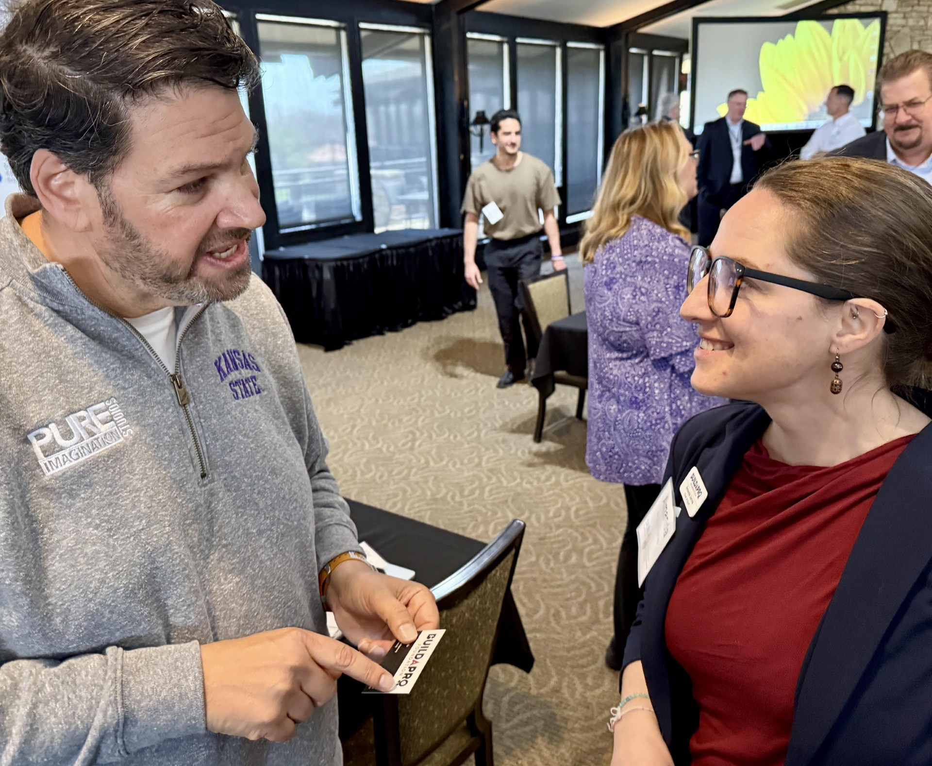 Joshua Wexler speaks with Amanda Jarvis at a Salina economic development gathering