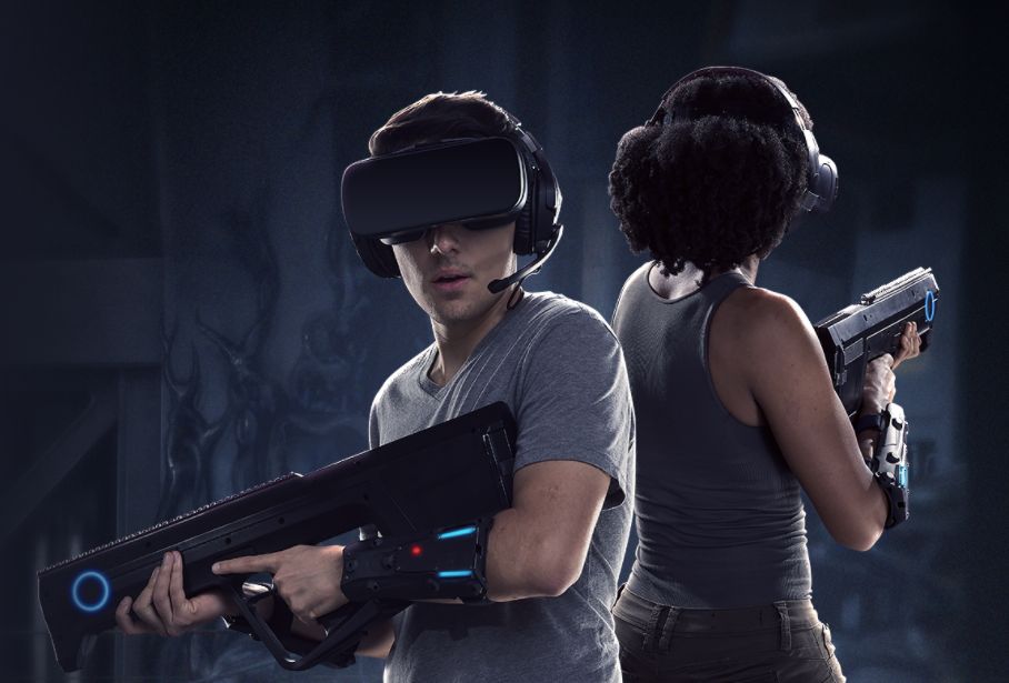 Two Alien: Descent participants wearing VR headsets and holding tracked prop rifles