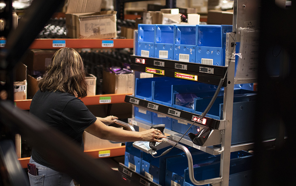 Operator batch picking orders with a light-directed warehouse cart