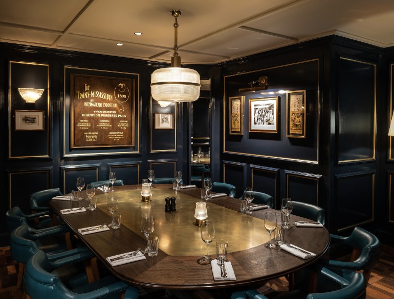 Lord Bronx private dining room at Hawksmoor NYC, with a set table and dark paneled walls