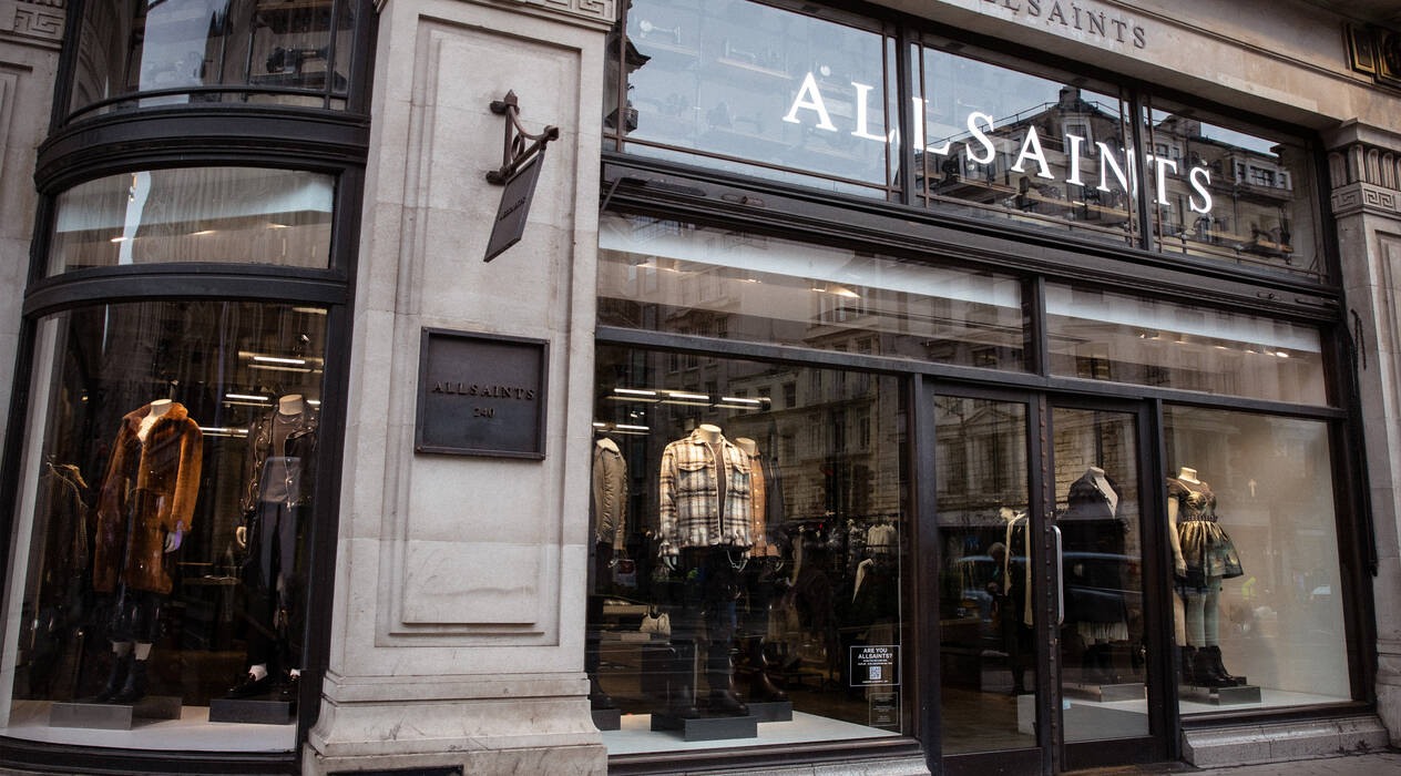 AllSaints storefront with mannequins visible through the glass