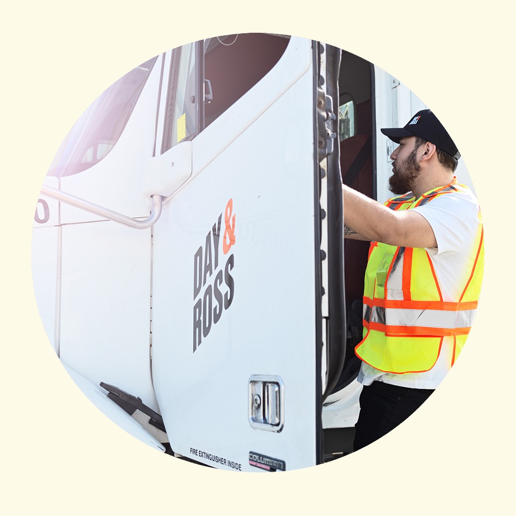 Day and Ross driver beside a branded truck