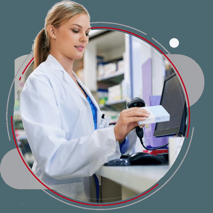 A pharmacy professional working at a computer in QS/1’s website photography