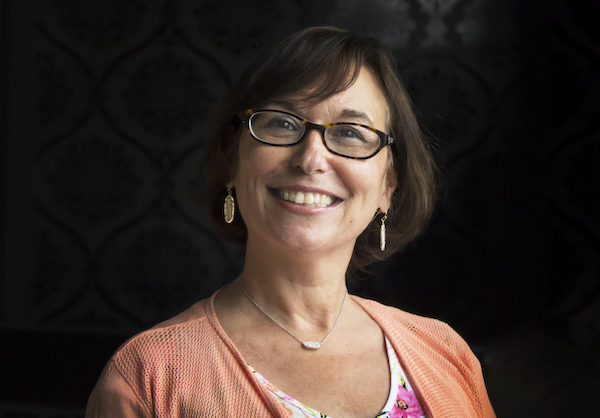 QtheAgency president and co-founder Linda Schuster seated in the agency office