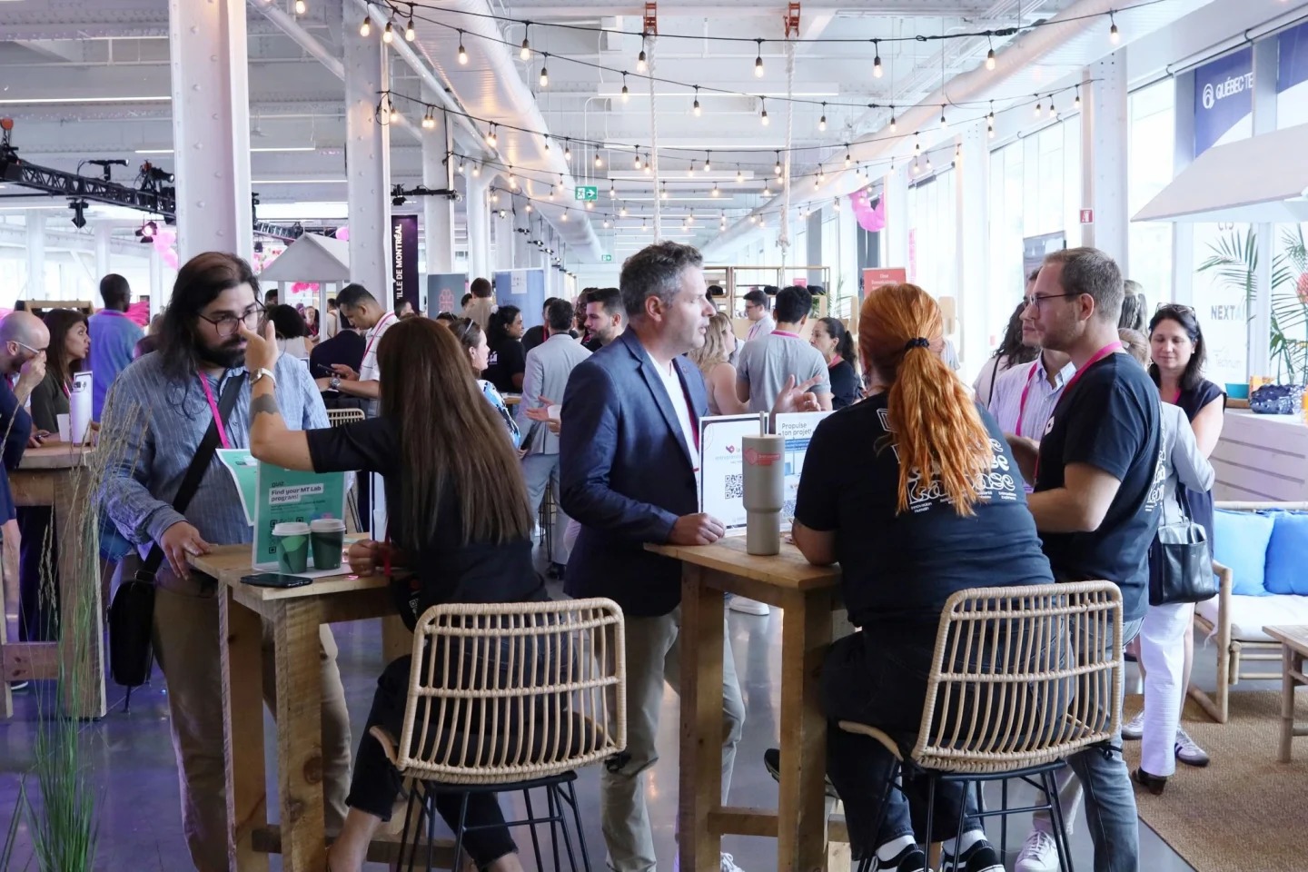 Founders and ecosystem partners talking inside the Québec Tech zone at Startupfest