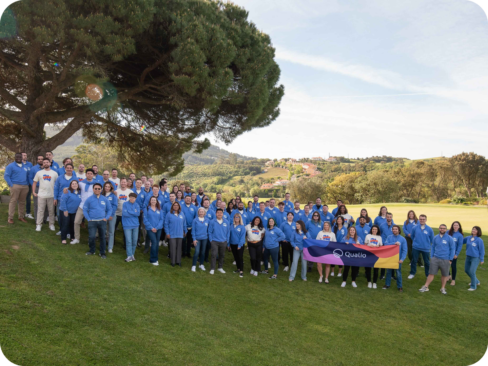 Qualio employees gathered outdoors for a company team photograph