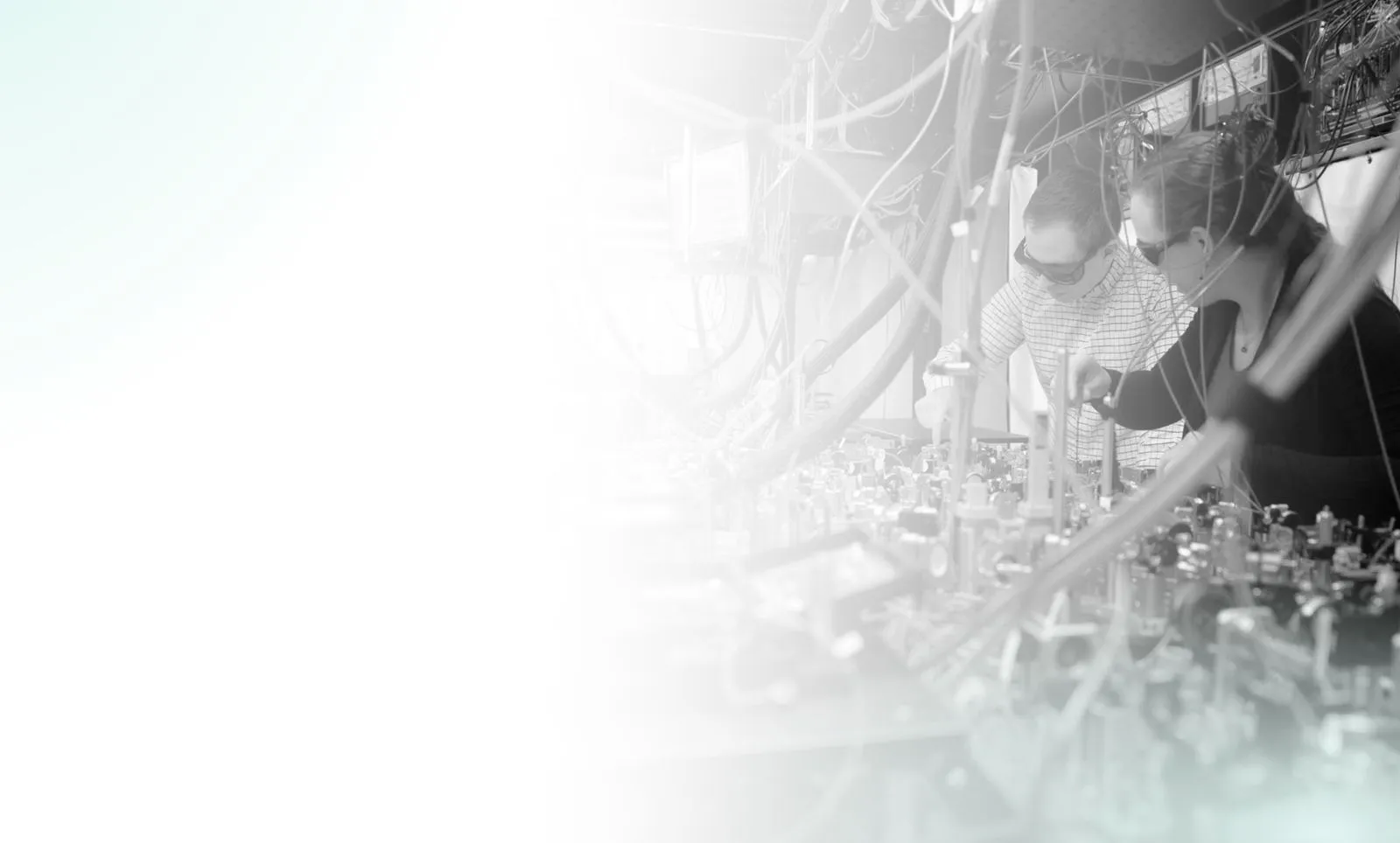 Quantinuum scientists working among optical equipment in a laboratory