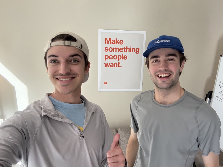 Quentin Romero Lauro and Michael Klikushin together beside a Make something people want poster