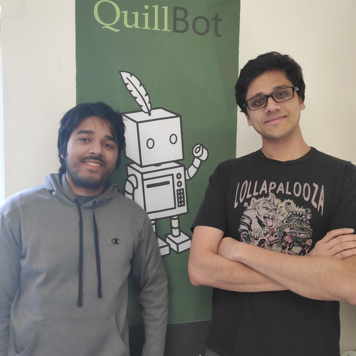 QuillBot co-founders Anil Jason, left, and David Silin beside the early robot mascot