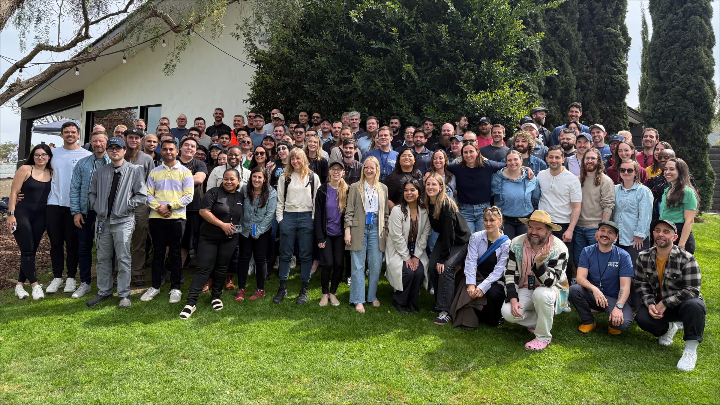 Quo team gathered outdoors for a company photograph
