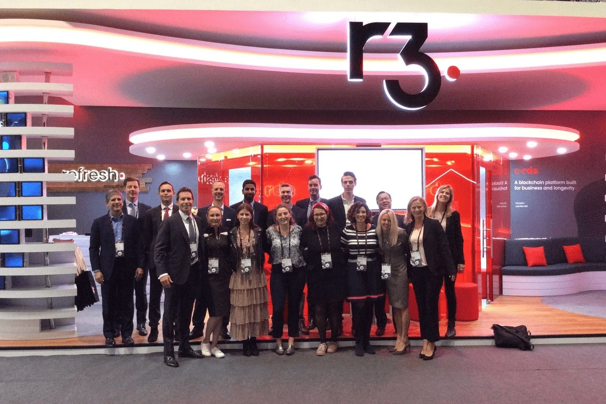 An R3 team group gathered at the company’s exhibition stand