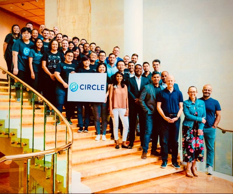 Raagulan Pathy with Circle colleagues gathered on a staircase, several wearing Circle shirts