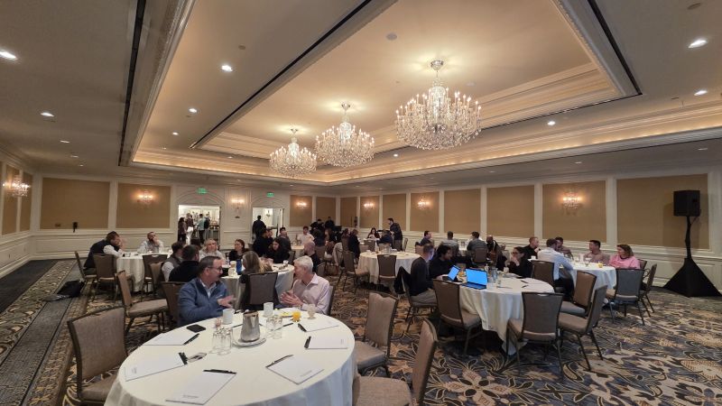 Actionstep colleagues gathered at round tables during a company sales kickoff in San Francisco