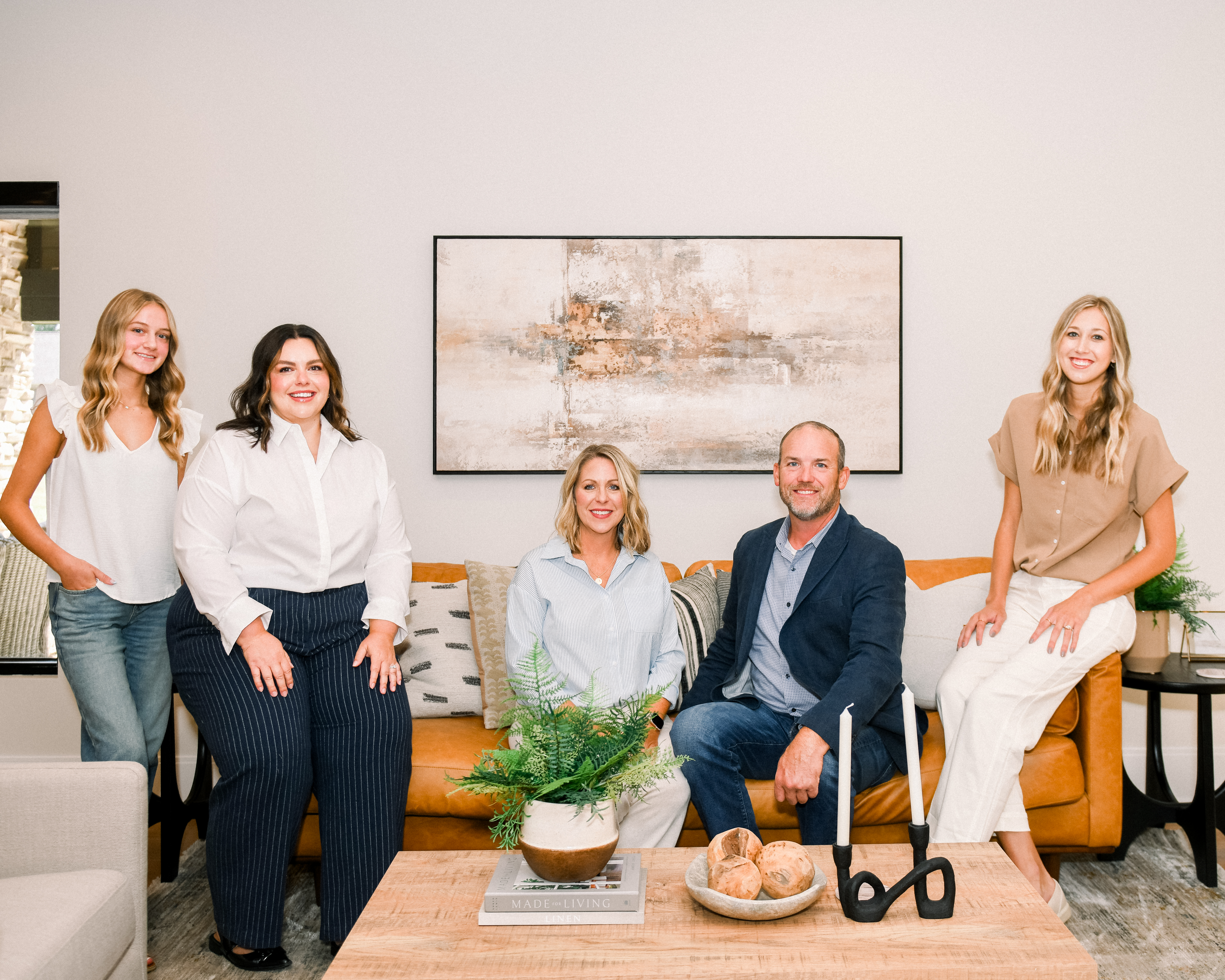 Rachel Collins seated with Jeff Collins and members of the Salted Hue Interiors team