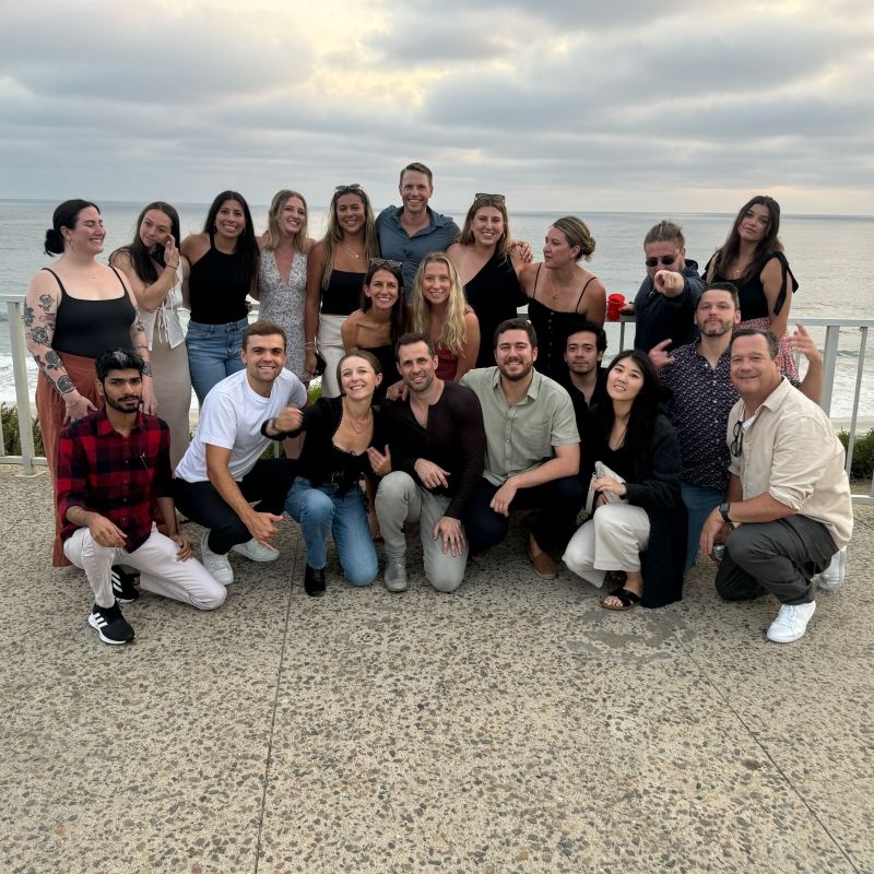 Arketa colleagues gathered together beside the ocean at a team offsite