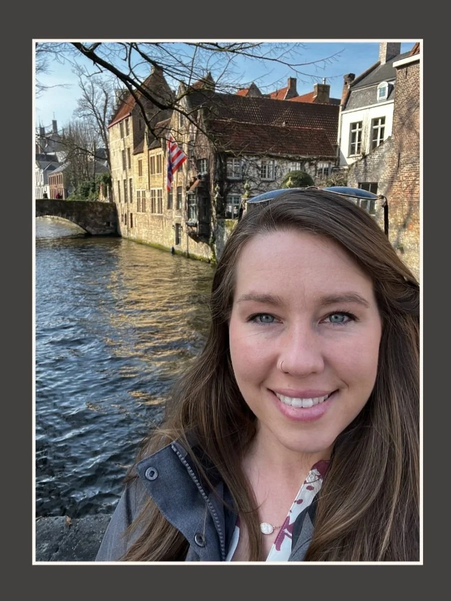 Rachel Sharpnack smiling beside a canal on a European trip