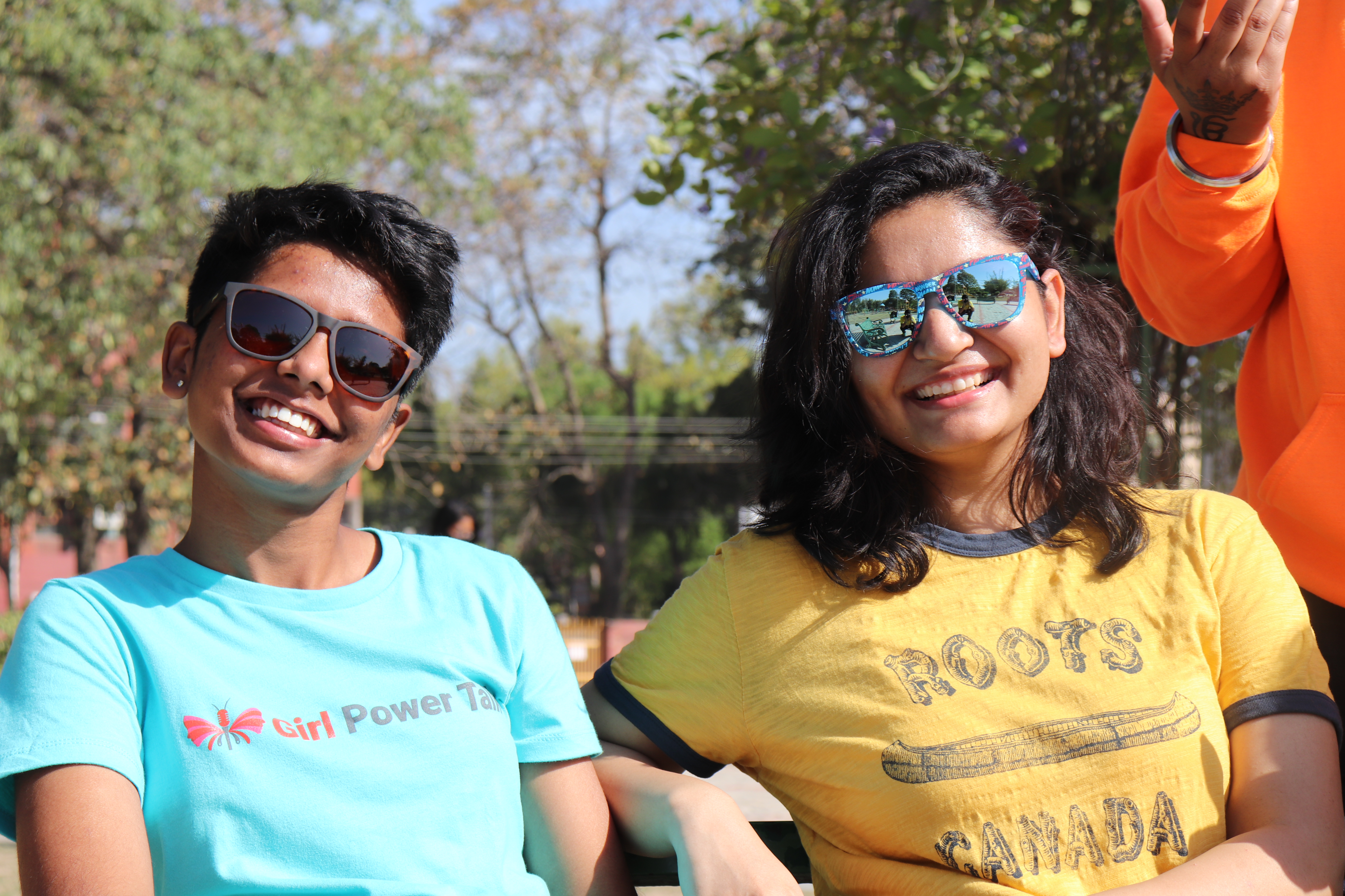 Rachita Sharma smiling outdoors beside a Girl Power Talk colleague