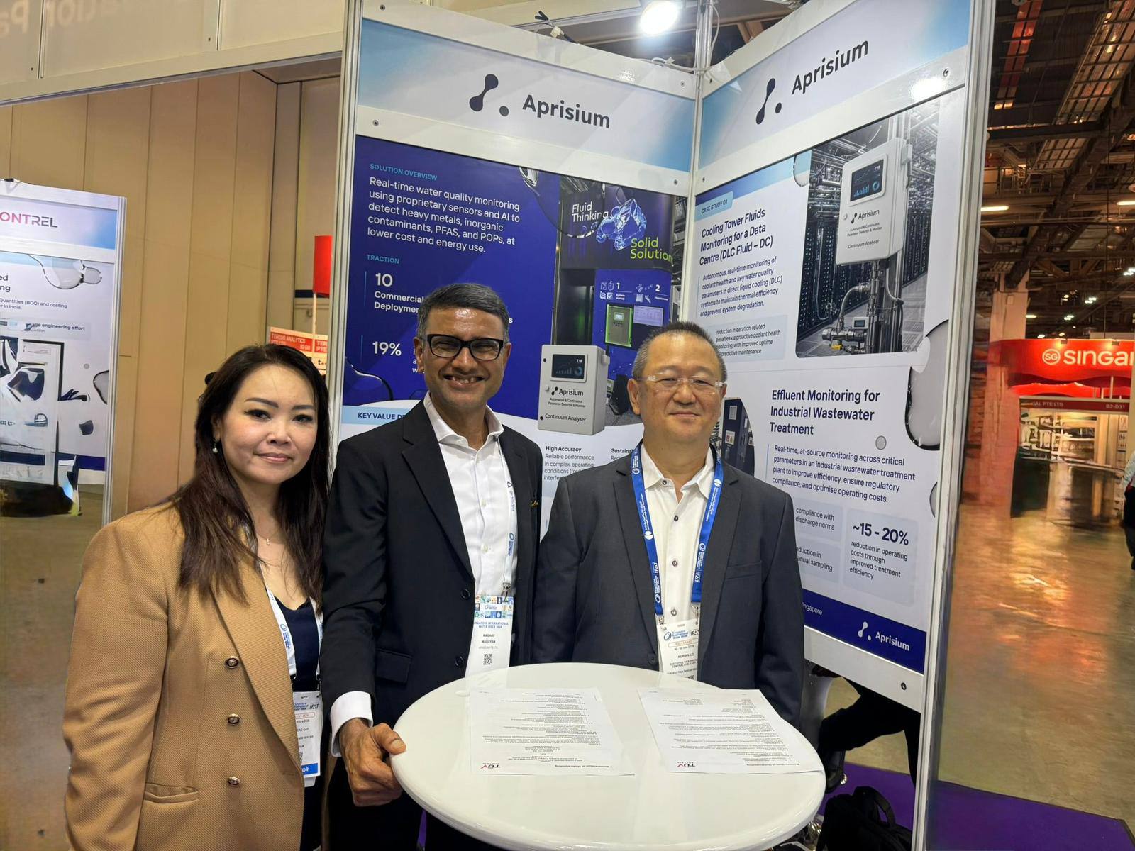 Raghav Narayan, centre, with two attendees at the Aprisium exhibition stand