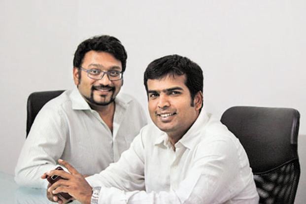 TaxiForSure co-founders Aprameya Radhakrishna, left, and Raghunandan G, right, seated together