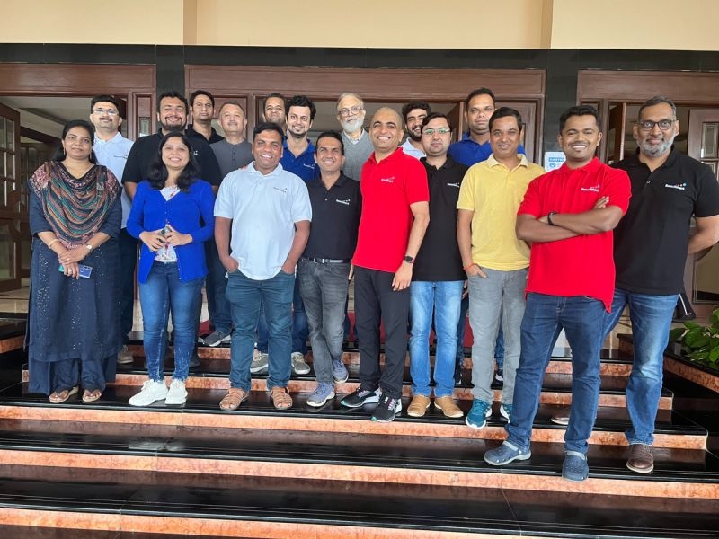 Benchmark leadership team and advisers gathered on steps during their overnight strategy offsite